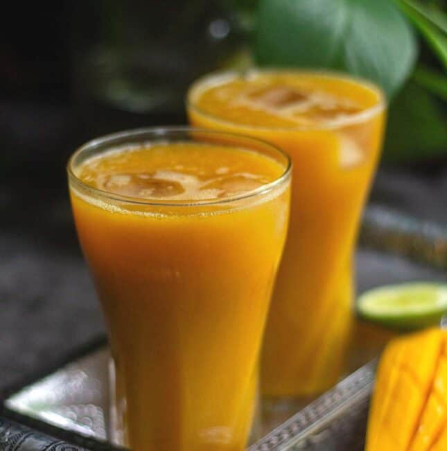 square image of mango iced tea served in two glasses