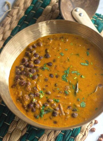 square image of kadala curry served in brassware