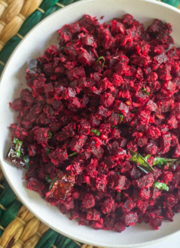 square image of beets stir fry served in white bowl placed on green mat