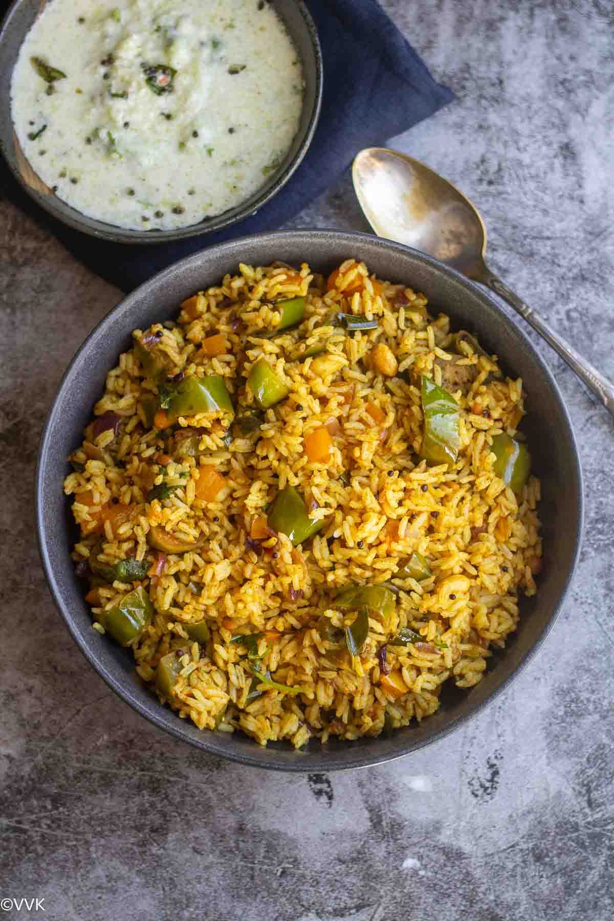 overhead shot of brinjal rice with cucumber raita
