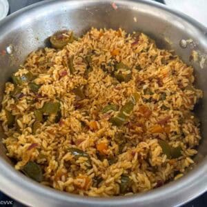 adding peanuts and mixing the rice