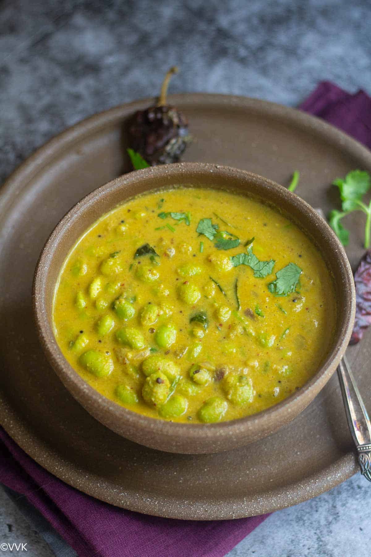 slanting shot of edamame huli saaru served in ceramic bowl