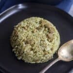 vegan mint pulao with soya served in black plate with a spoon on the side