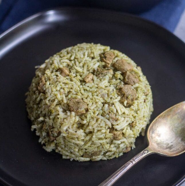 vegan mint pulao with soya served in black plate with a spoon on the side