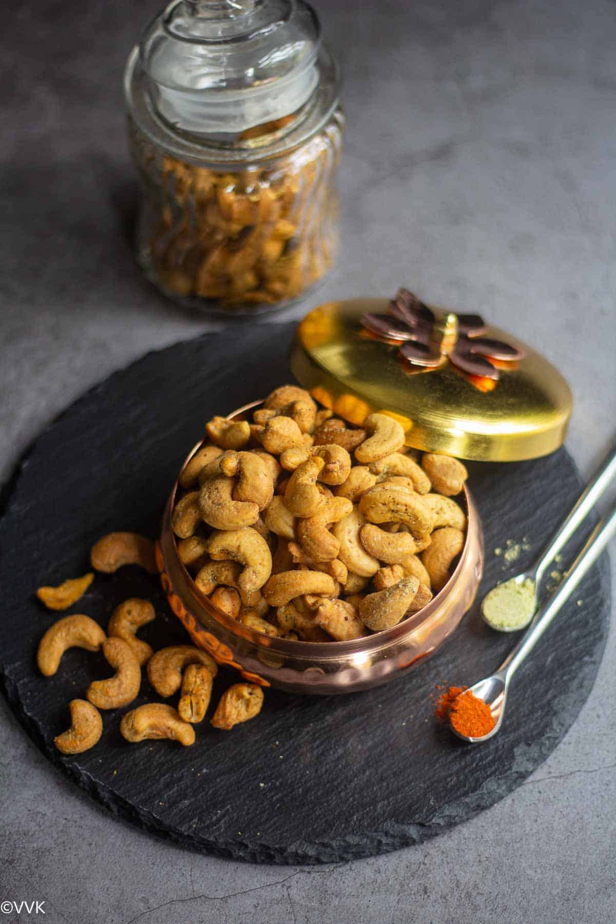 air fryer roasted cashews in a gifting bowl placed on black slate