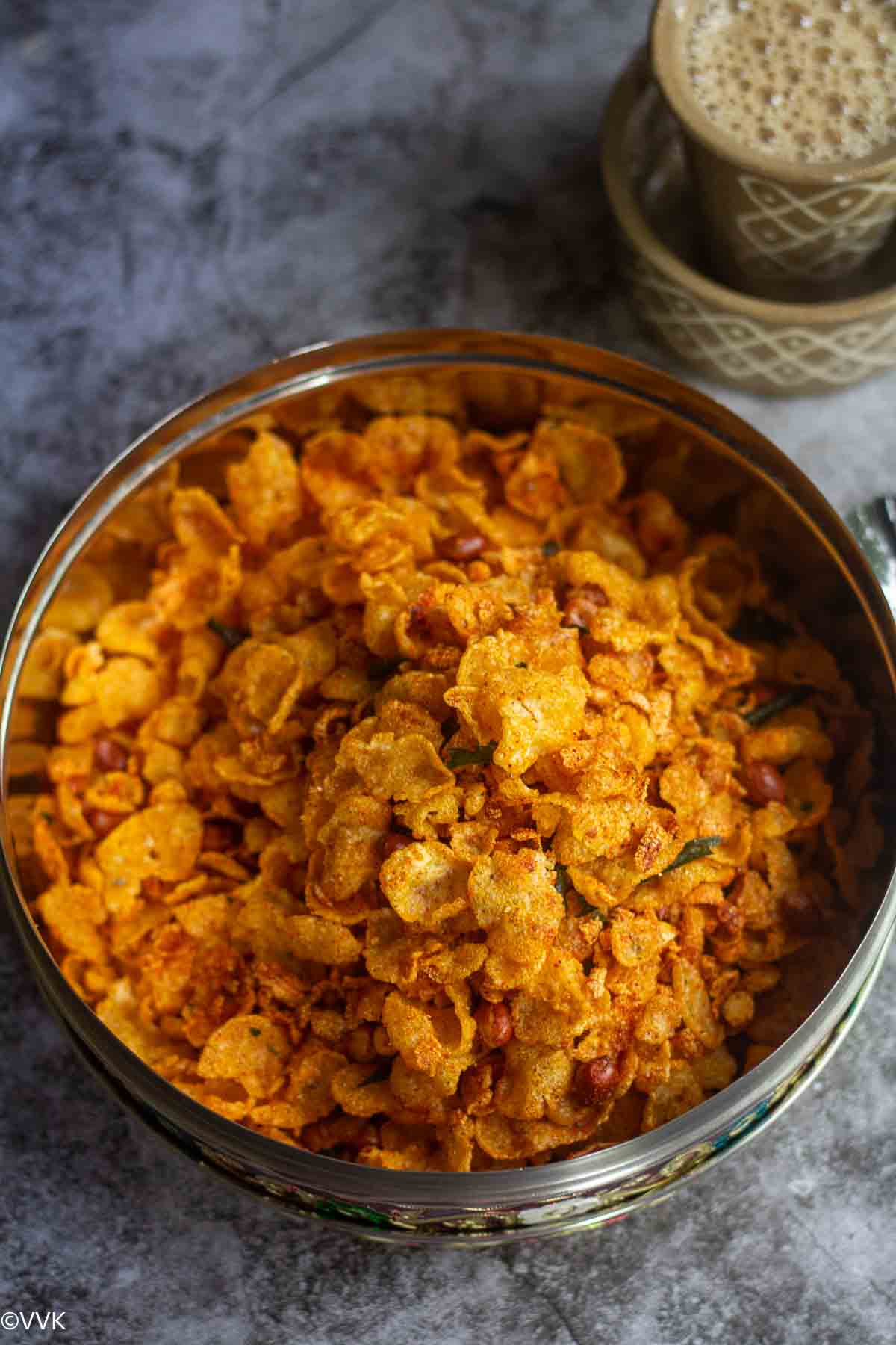 close up shot of makkai poha mixture served with coffee