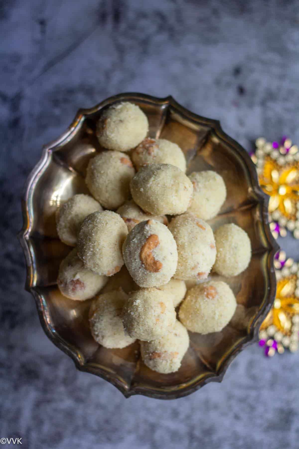 Top angle view of rava laddu in a silver plate