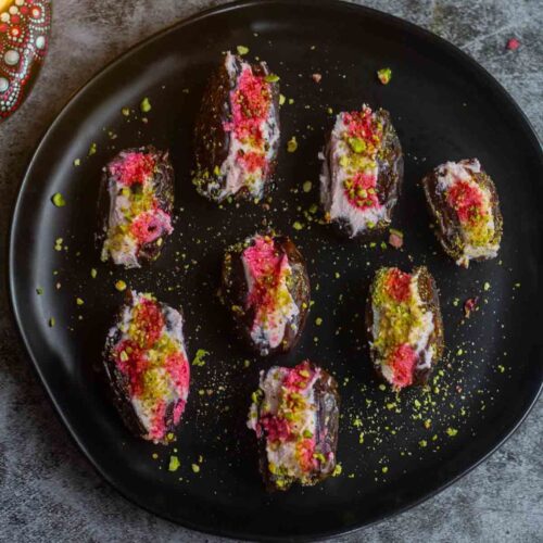 square image of ricotta stuffed dates served in black plate