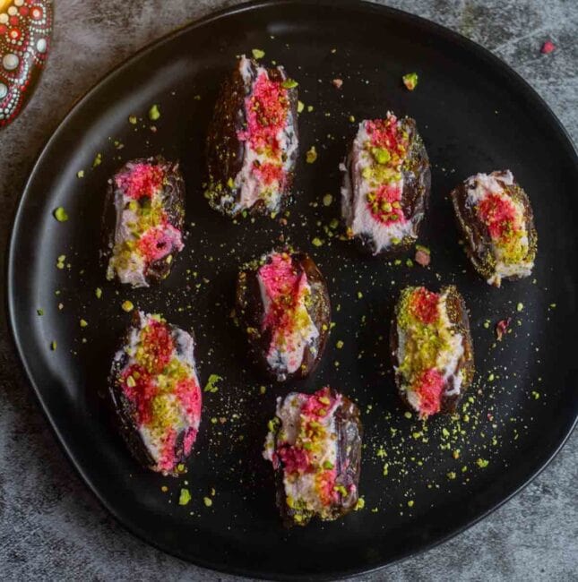 square image of ricotta stuffed dates served in black plate