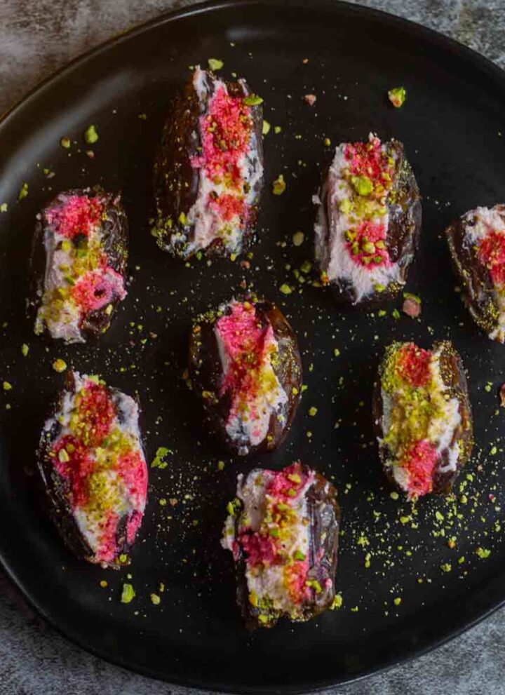 square image of ricotta stuffed dates served in black plate