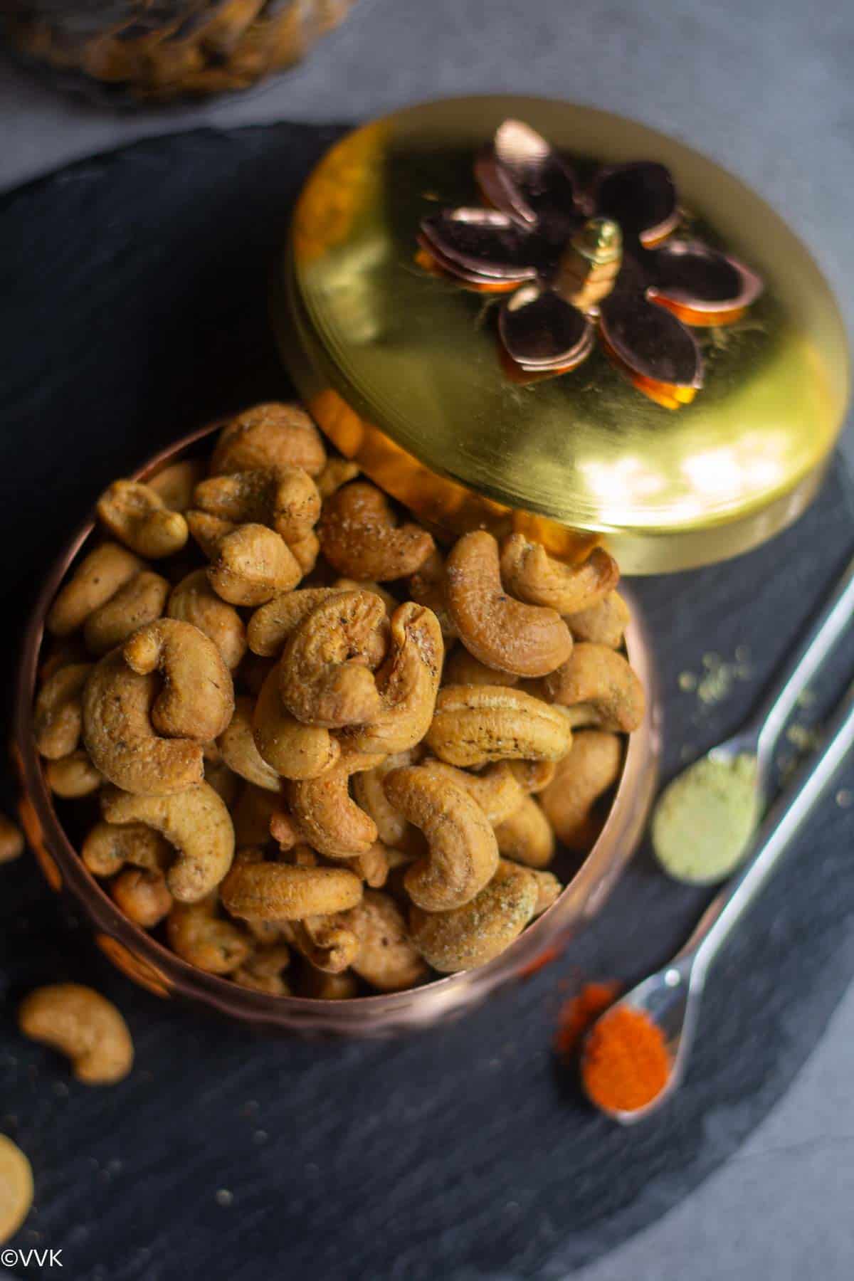 overhead shot of air fryer cashews in a gifting bowl placed on black slate