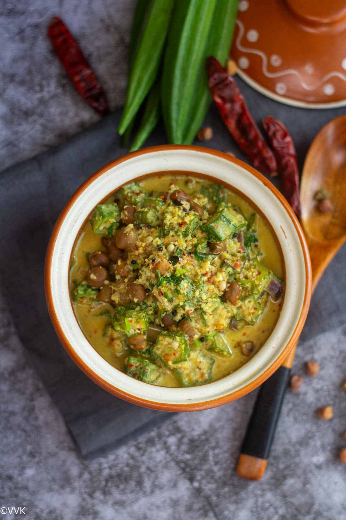 overhead shot of okra kootu served in terracotta bowl