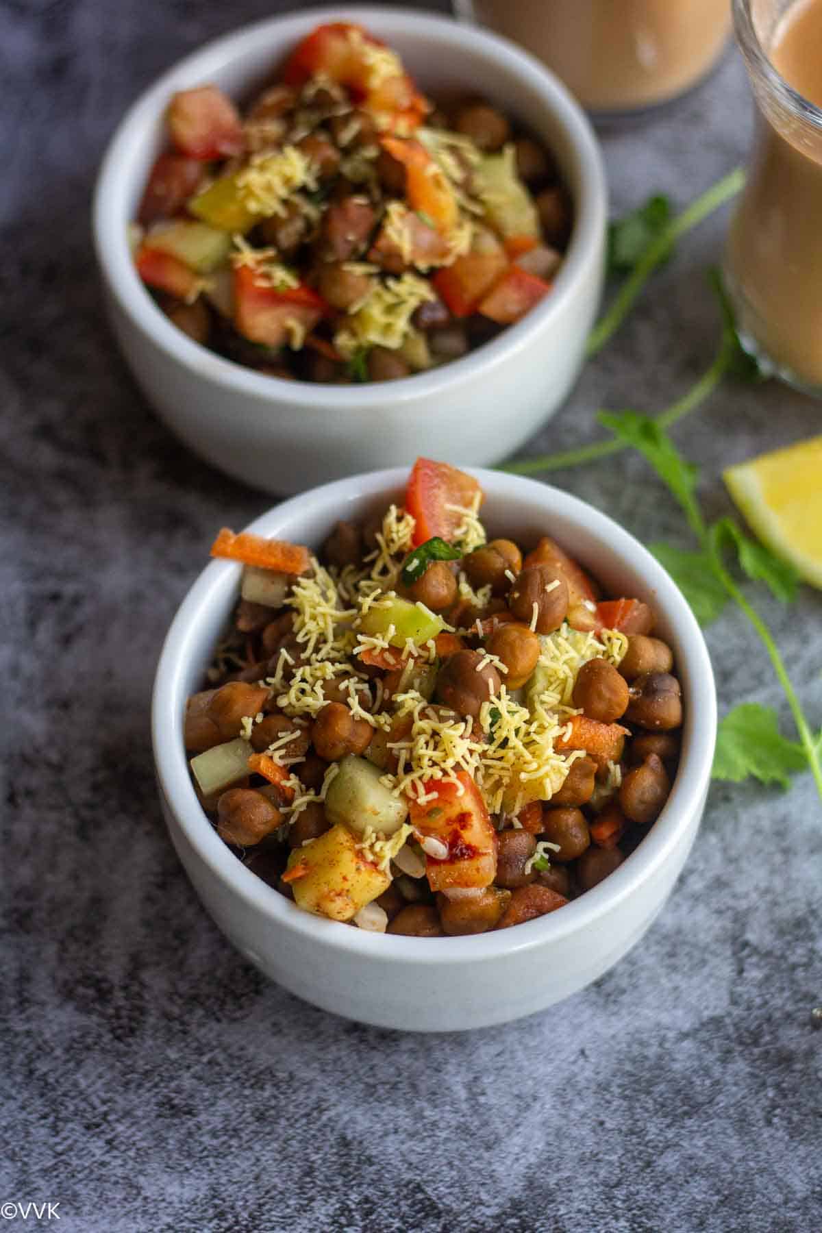karuppu kondakadalai sundal or chaat in white bowls with tea on the right
