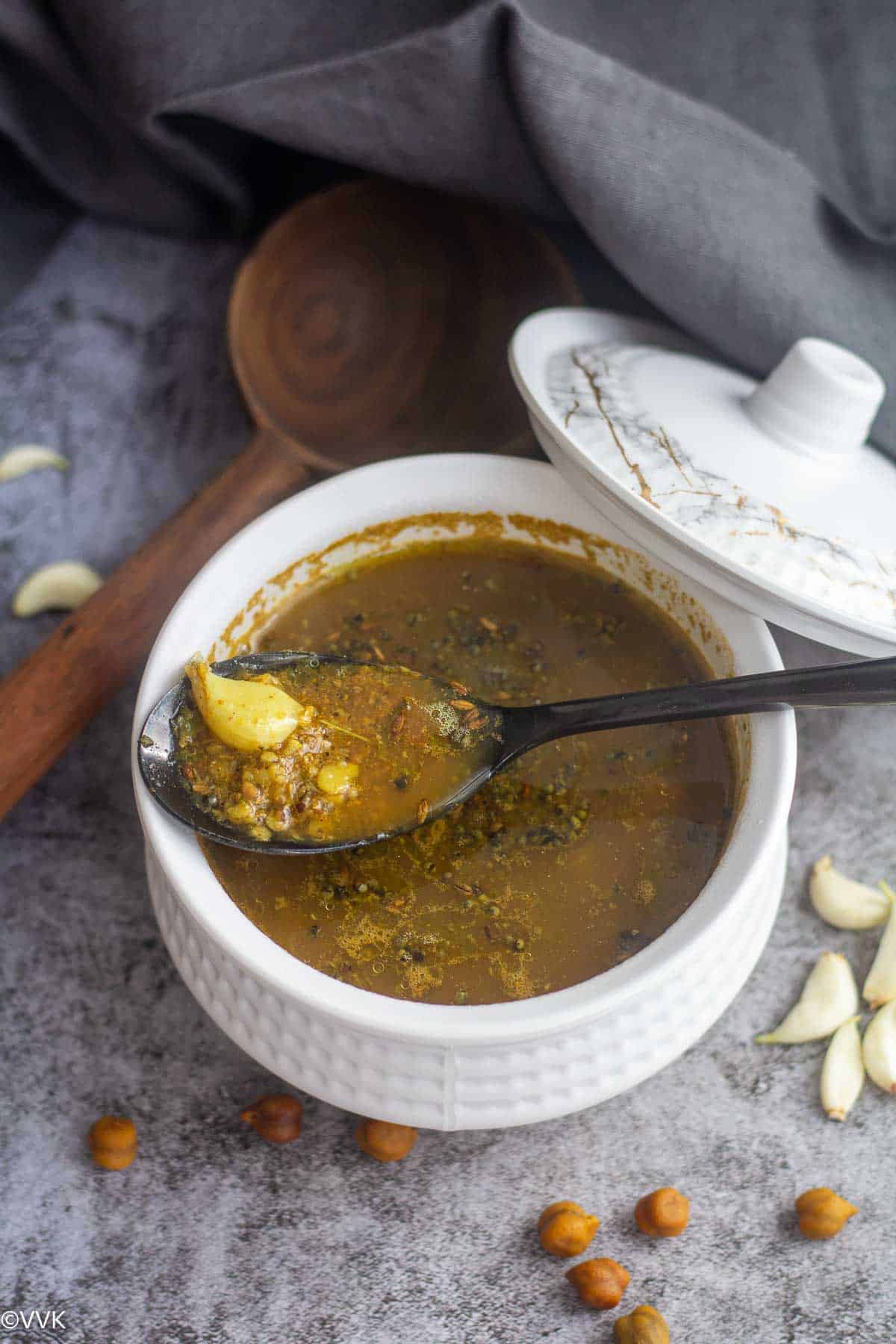 close up shot of kadala rasam served in white bowl