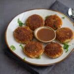 square image of aloo tikki served with sweet chutney
