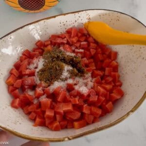 adding salt and tempering to the chopped carrots