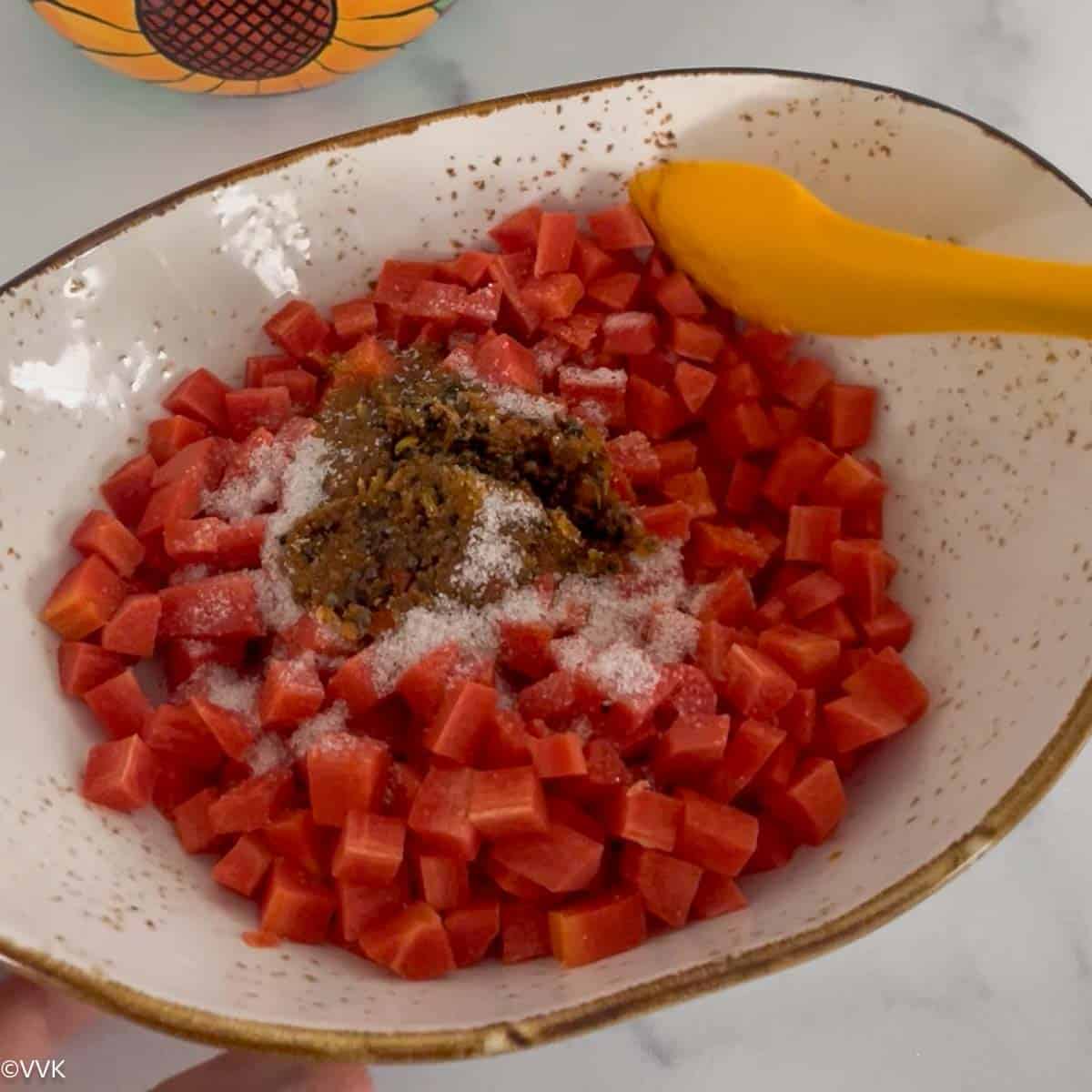 adding salt and tempering to the chopped carrots