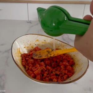 adding freshly sqeezed lemon juice to the carrot pickle