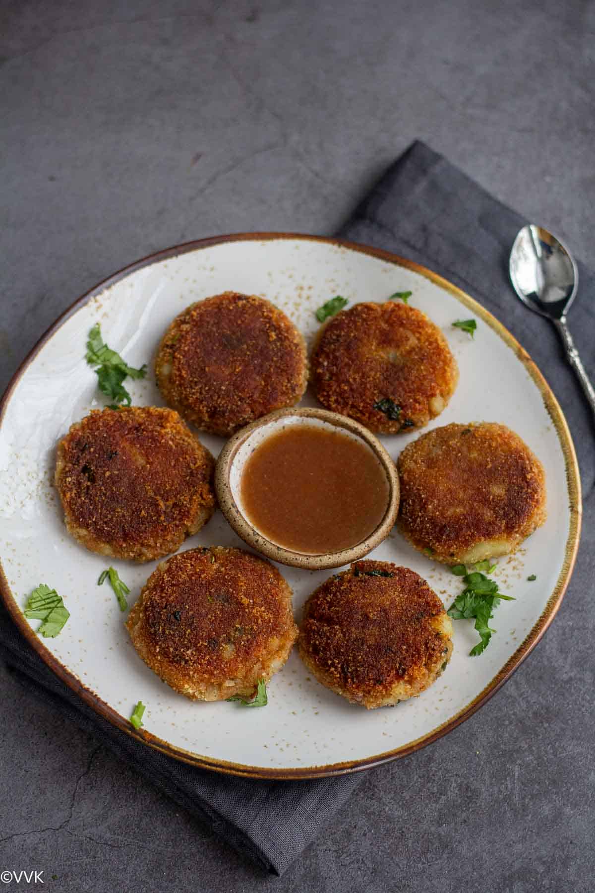 aloo tikki served with sweet chutney in a plate
