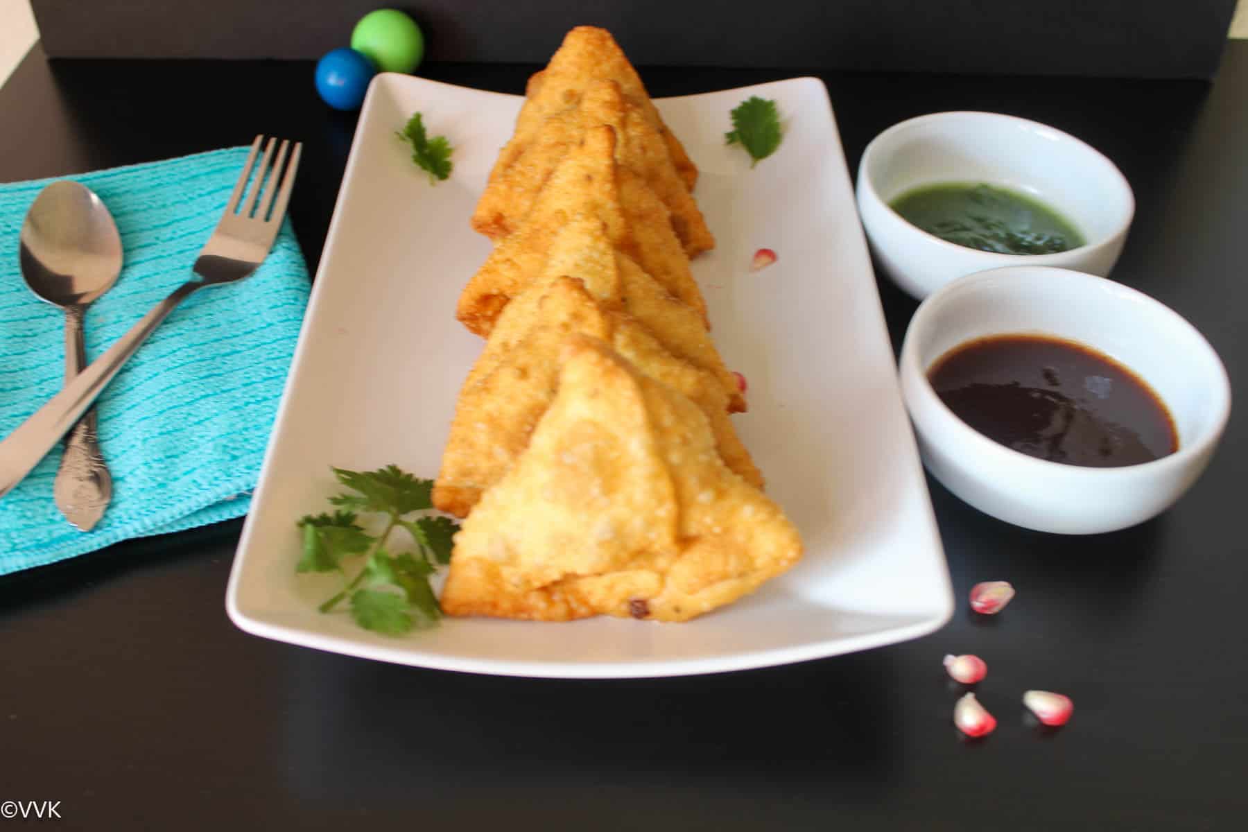 lined up samosas served with chutneys