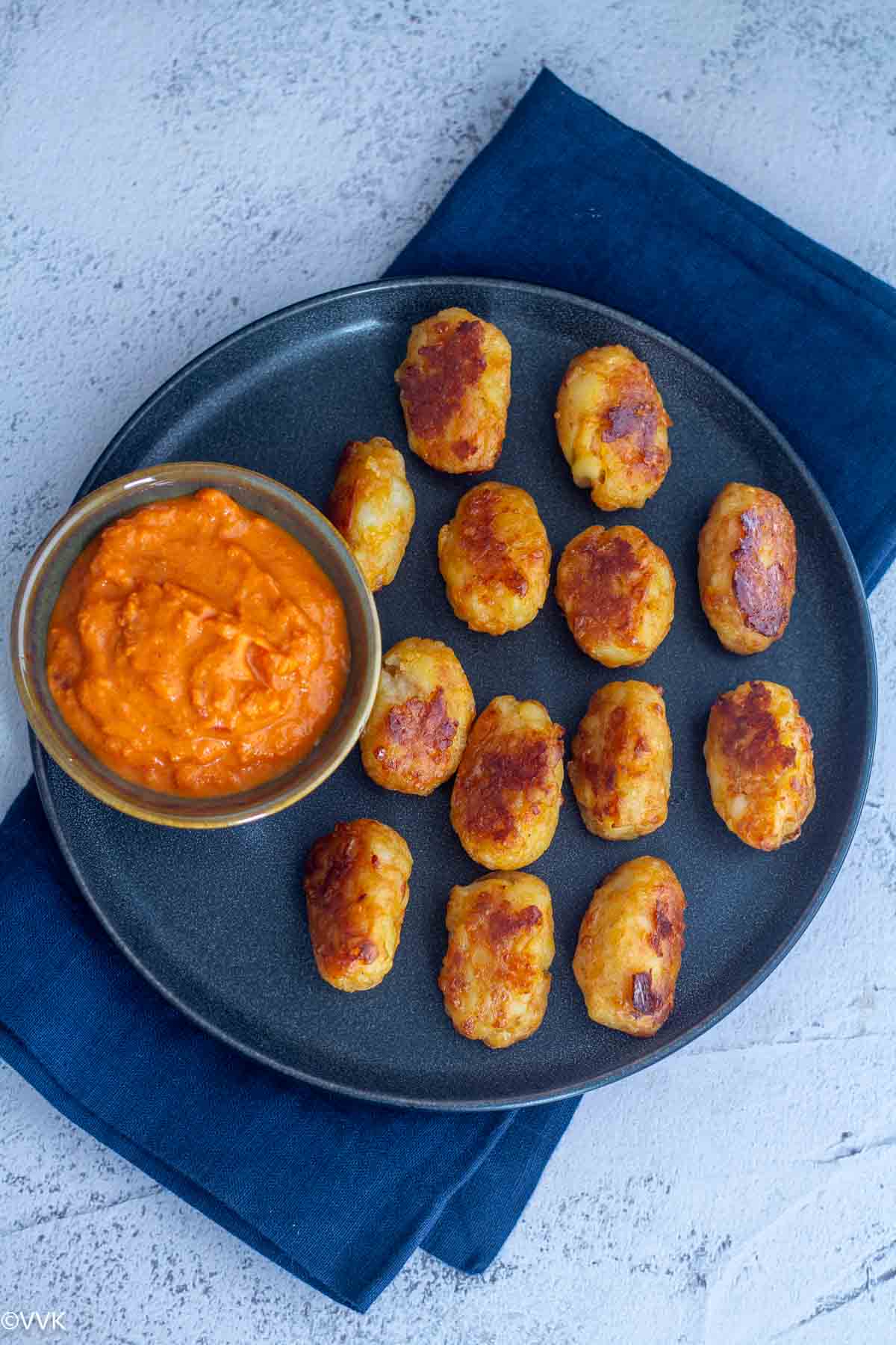 overhead shot of baked tater tots served with marinara
