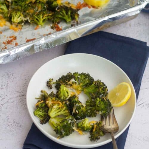 square image of oven roasted broccoli in a plate