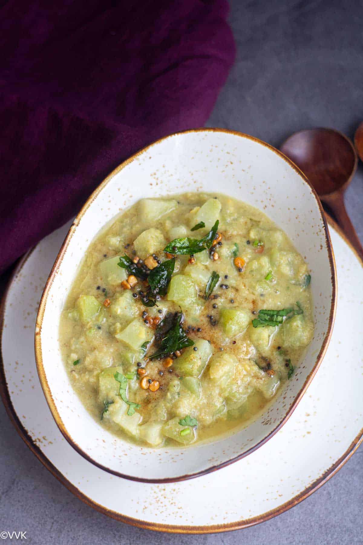 chow chow kootu served in a ceramic ware with tempering on the top