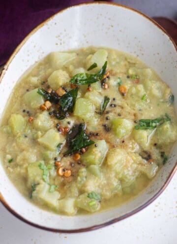 square image of chayote kootu served in ceramic serveware