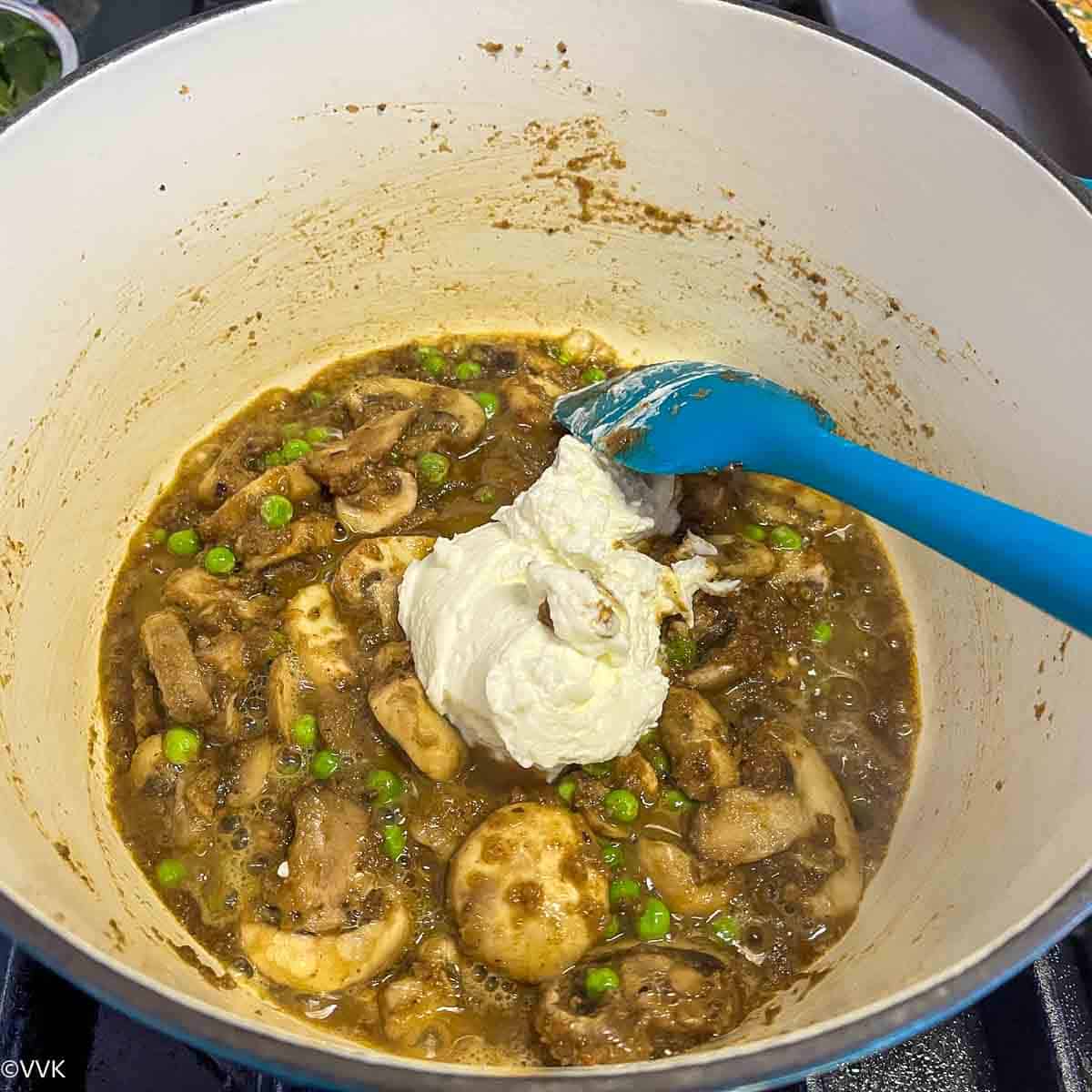 adding yogurt to the biryani masala and vegetables