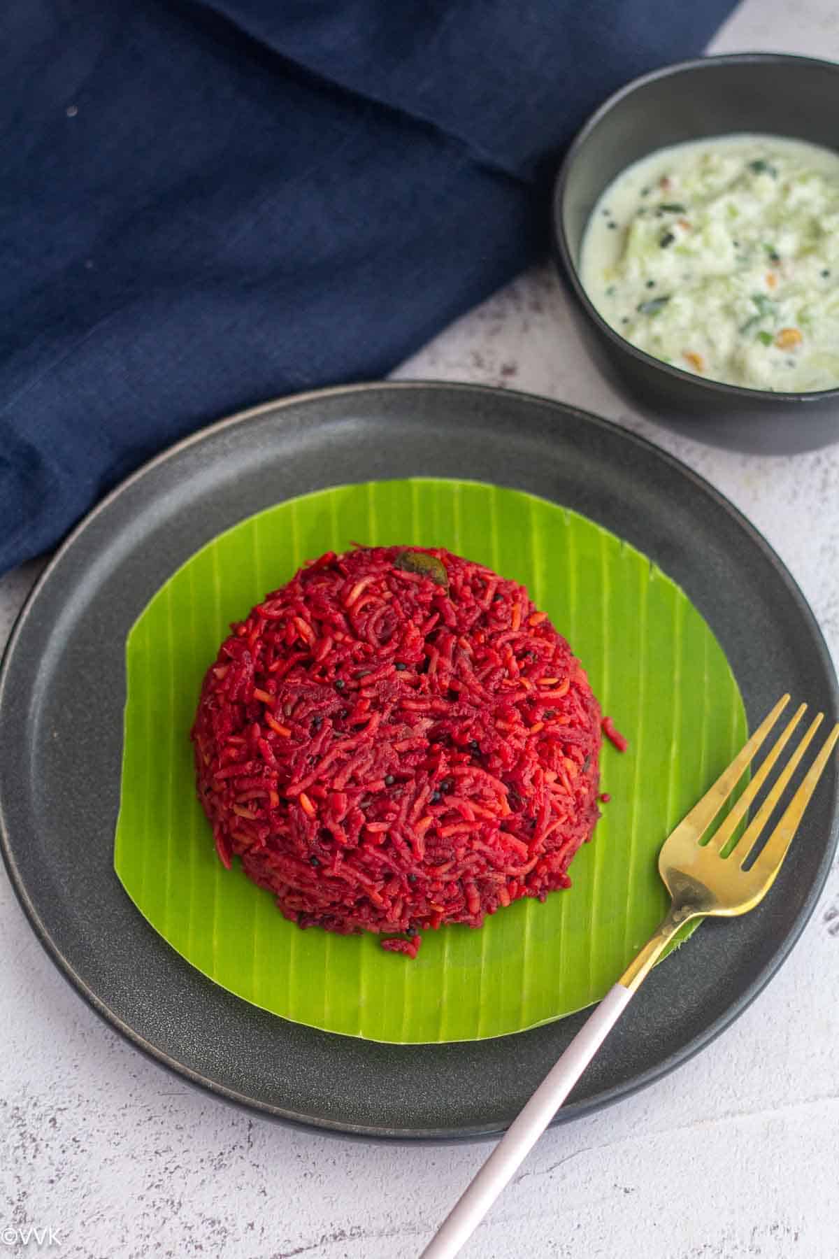 beets rice made in Instant Pot placed on a plate with a banana leaf lined with fork on the side