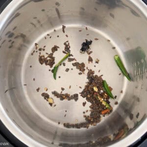 adding whole spices and green chilies