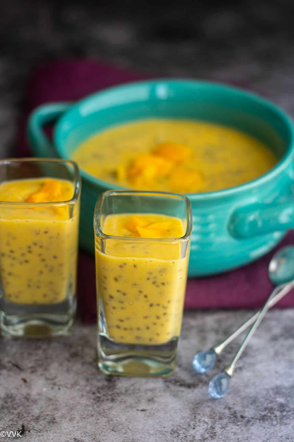 close shot of chia pudding with mango served in two glasses