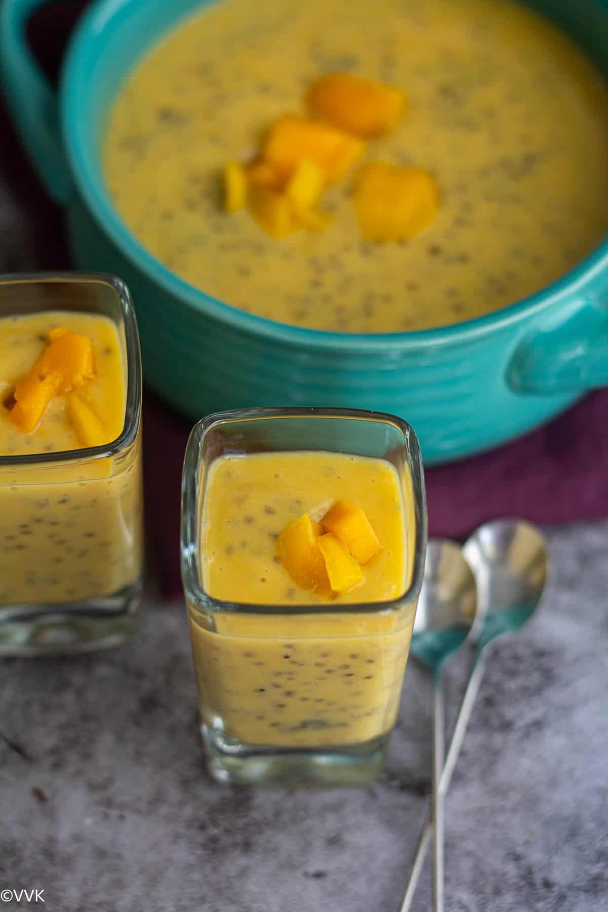 close up shot of mango chia pudding served in single serve glass