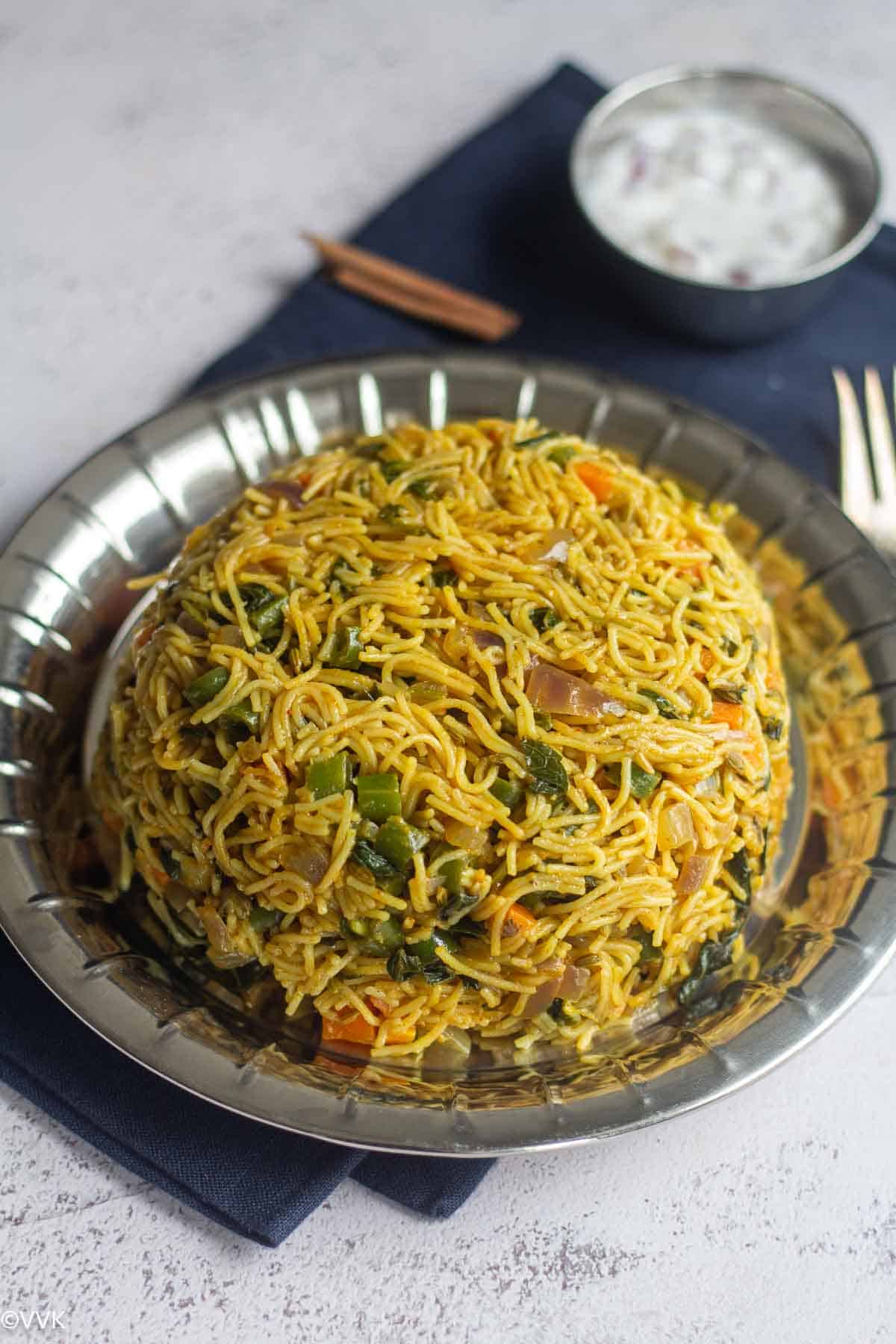close up shot of vermicelli pulao placed on stainless steel plate