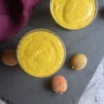 square image of mango smoothie served in a glass