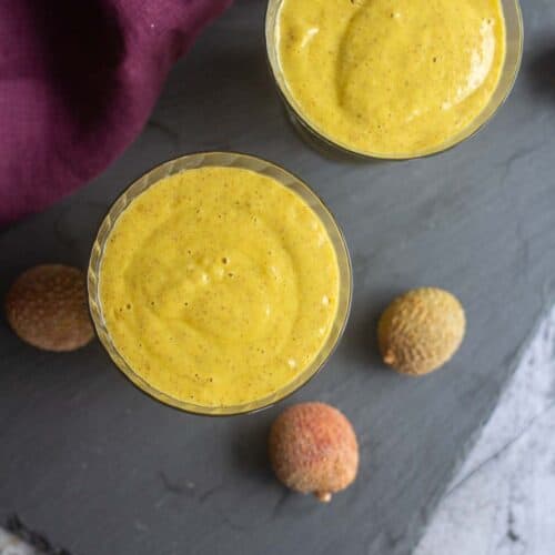 square image of mango smoothie served in a glass