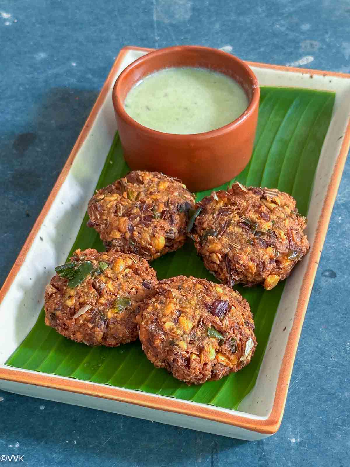 close up shot vaazhai poo vadai served with coconut chutney