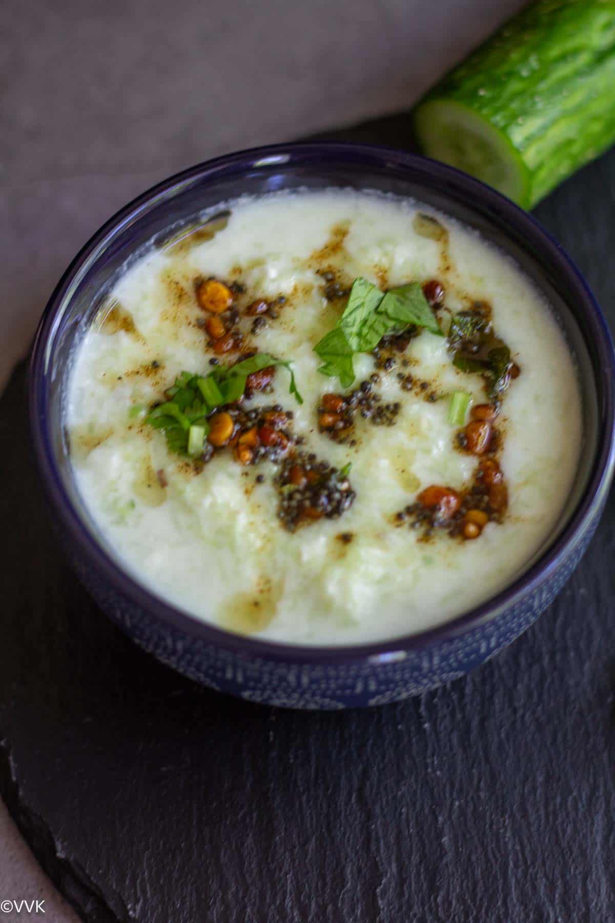 close up shot of cucumber raita with tempering on the top