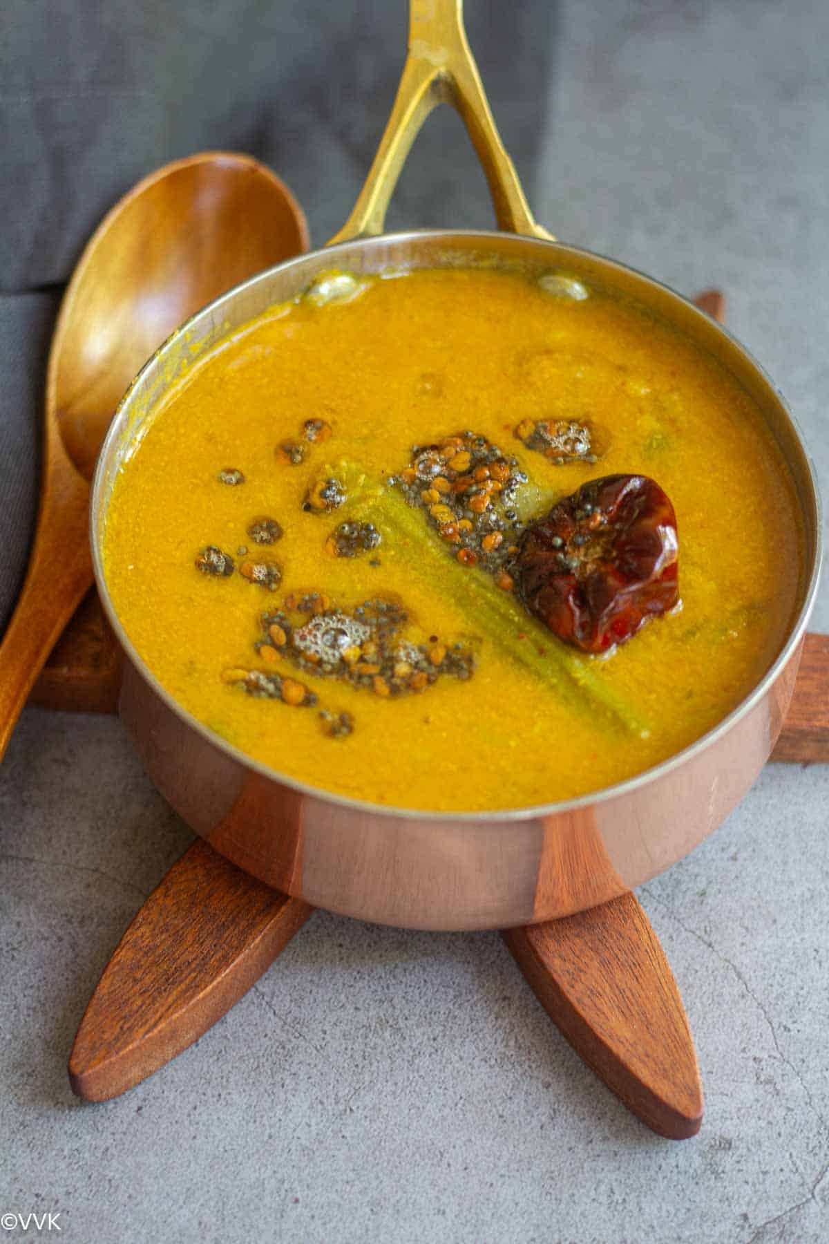 close up shot of drumstick sambar with tempering on the top