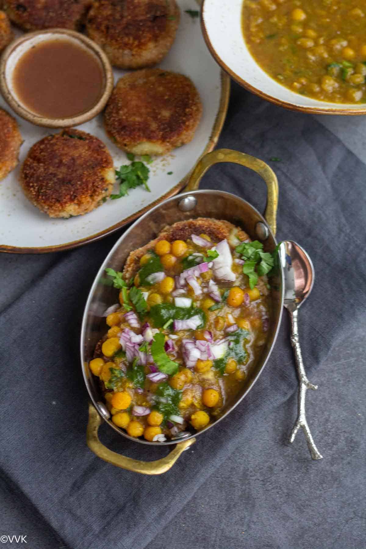 overhead shot of ragda pattice with aloo tikki on the side