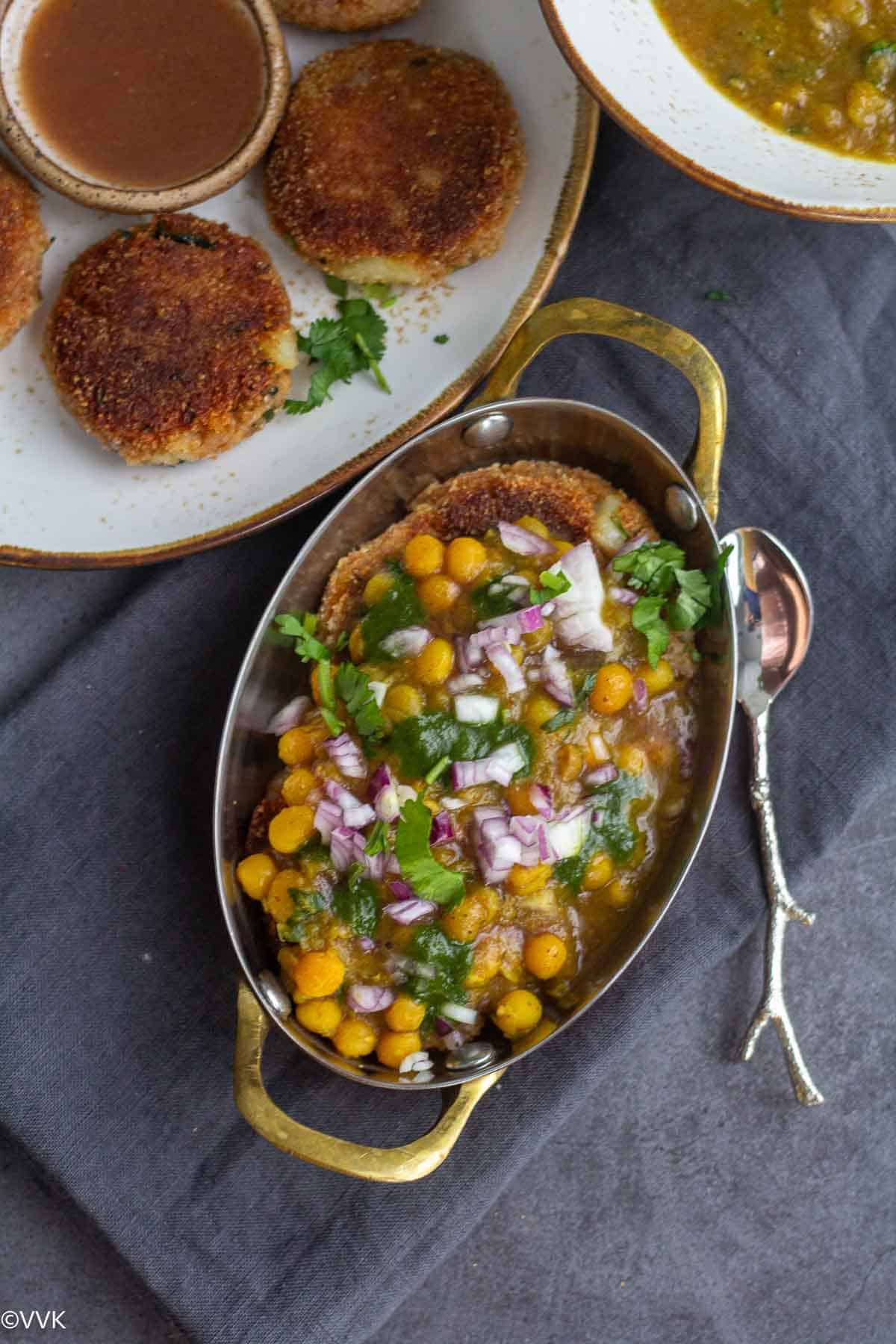 overhead shot of ragda pattice served in traditional serveware placed on gray towel