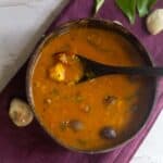 square image of palakottai sambar served in coconut bowl