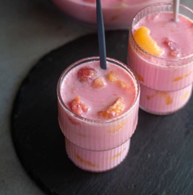 square image of hwachae served in two glasses with spoon inside