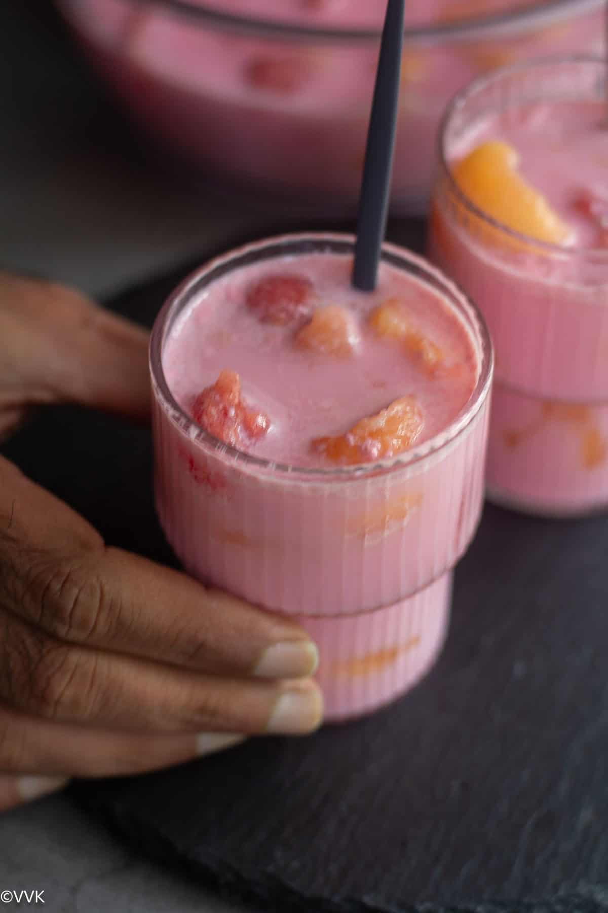 person holding Korean fruit punch hwachae