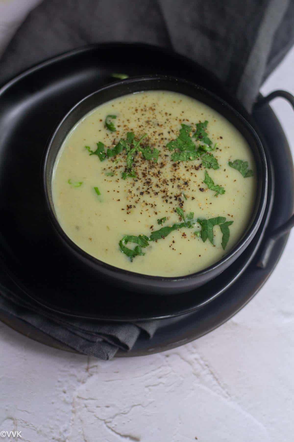 close up shot of sorakkai soup served in black bowl